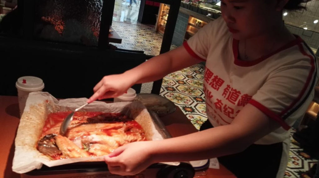 The real deal; Metallicman and family having "paper fish" at a restaurant. The fish is cooked in a paper wrap with all sorts of spices and tasty vegetables. It is so very super delicious! So yes, I eat far better now than then, but it's not always steaks, don't you know.