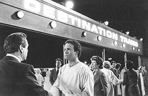 In the movie "Defending your life", the recently deceased person is put on trial to defend his actions during his lifetime. Here, his "attorney" / advocate wishes him a firm goodbye as he leaves for his next reincarnation.