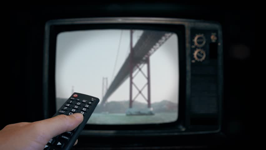 Turning off an old television set.
